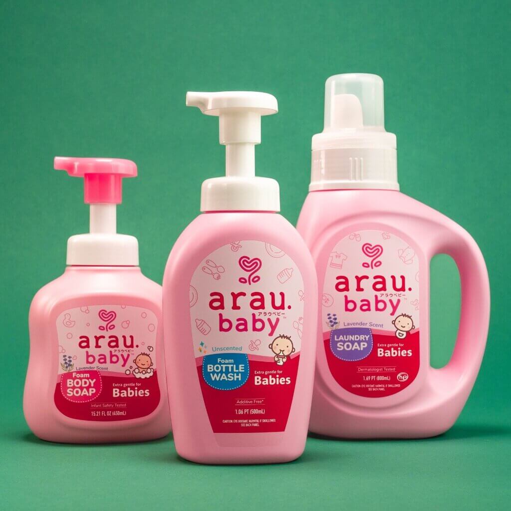 arau baby complete set, body wash, bottle wash and laundry soap over green background